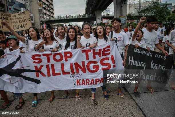 Residents and activists chant slogans during the funeral procession of Kian Loyd Delos Santos in Caloocan, Metro Manila, Philippines, August 26,...