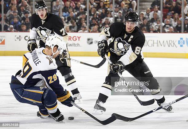 Jason Pominville of the Buffalo Sabres and Sidney Crosby of the Pittsburgh Penguins battle for the loose puck December 8, 2008 at Mellon Arena in...