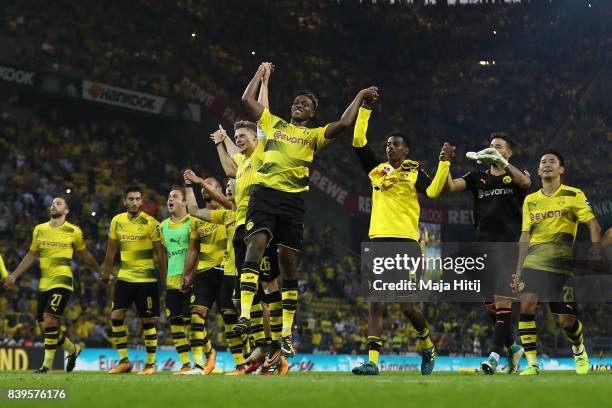 Lukasz Piszczek of Dortmund and Dan-Axel Zagadou of Dortmund and players of Dortmund celebrate with their fans after the Bundesliga match between...