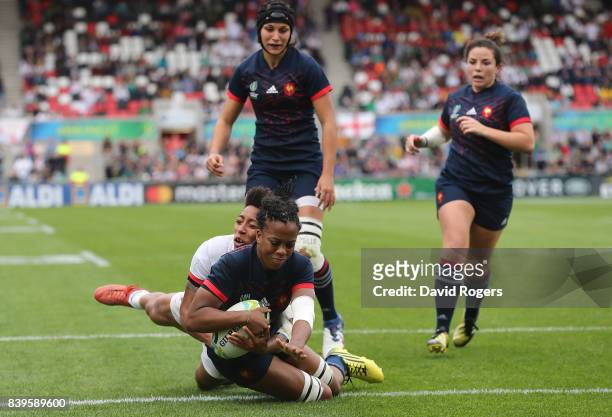Julie Annery of France breaks clear from the tackle of Kris Thomas of The USA to score a try during the Women's Rugby World Cup 2017 Third Place...