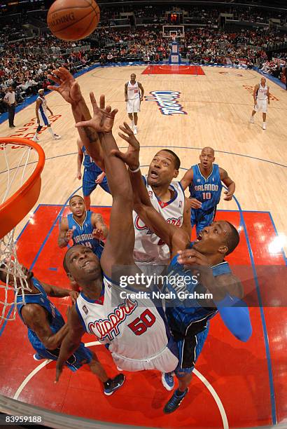 Zach Randolph and Marcus Camby of the Los Angeles Clippers reach for the ball against Dwight Howard of the Orlando Magic at Staples Center on...