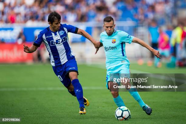 Jordi Alba of FC Barcelona duels for the ball with Oscar Romero of Deportivo Alaves during the La Liga match between Deportivo Alaves and Barcelona...