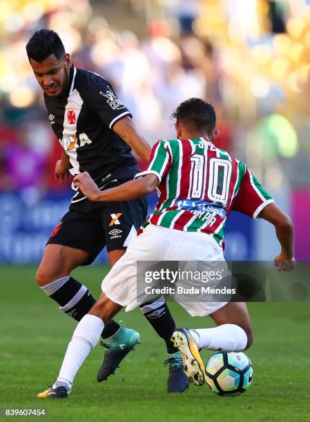 Gustavo Scarpa of Fluminense struggles for the ball with Andres Rios of Vasco da Gama during a match between Fluminense and Vasco da Gama as part of...