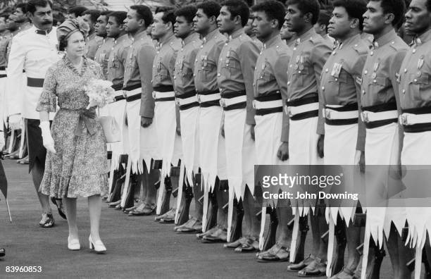 Queen Elizabeth II carries out a military inspection during a visit to Fiji, 1st November 1982.