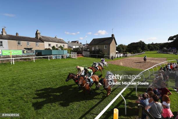 Horses and riders head out past the village of Cartmel at the start of the totepoolliveinfo.com Handicap Steeplechase race at Cartmel Racecourse on...