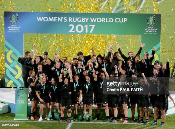 New Zealand's hooker Fiao'o Faamausili lifts the cup as New Zealand's players celebrate their victory on the pitch after the Women's Rugby World Cup...
