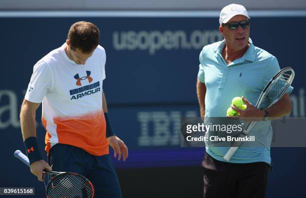 Andy Murray of Great Britian shows his frustrations as his coach Ivan Lendl looks on before withdrawing from the event during a practice session...