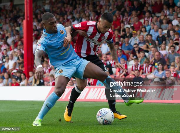Wolverhampton Wanderers' Ivan Cavaleiro battles for possession with Brentford's Nico Yennaris during the Sky Bet Championship match between Brentford...