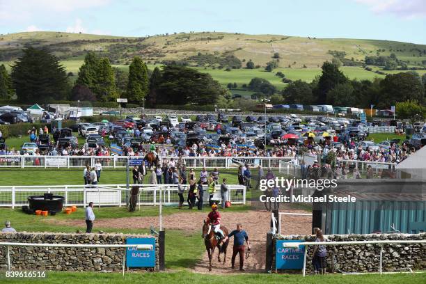 Jockeys head out onto the course ahead of the Hadwins Motor Group TBA Mares' Handicap Hurdle Race during Cartmel Races at Cartmel Racecourse on...