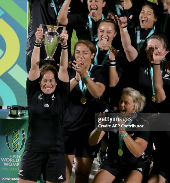 New Zealand's captain Fiao'o Faamausili lifts the cup as New Zealand's players celebrate their victory on the pitch after the Women's Rugby World Cup...