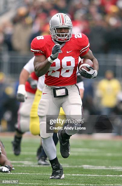 Chris Wells of the Ohio State Buckeyes carries the ball during the Big Ten Conference game against the Michigan Wolverines at Ohio Stadium on...