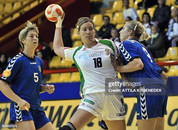 Hungarian Piroska Szamoransky scores a goal between Ukrainian Maryna Vergeliuk and Rehina Shymkute during the 8th Women's Handball European...