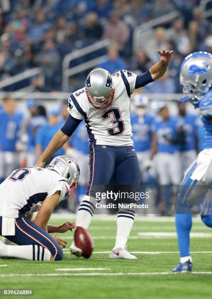 New England Patriots kicker Stephen Gostkowski kicks the ball for extra point after a touchdown as New England Patriots punter Ryan Allen holds the...