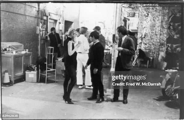 American fashion model and actress Edie Sedgwick stands with unidentified others during a party in pop artist Andy Warhol's studio, the Factory , New...