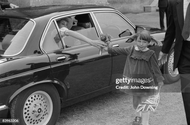 Diana, Princess of Wales receives a posy after a visit to a girls' public school near Highgrove, Gloucestershire, June 1985.