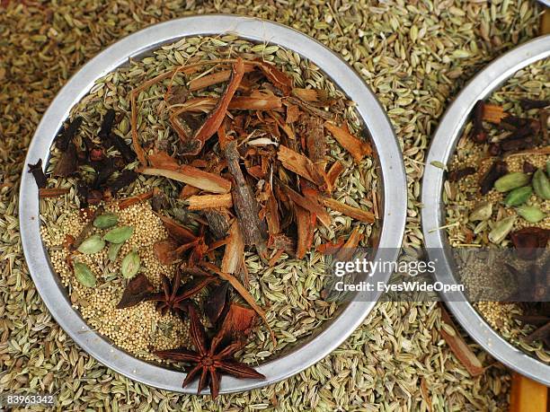 Street vendor offers fresh indian spices like star-anise, cardamom, cloves, cinnamon and fennel seeds to customers on January 06, 2008 in Trivandrum,...