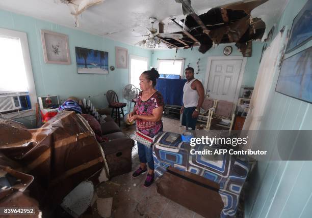Celina Martinez returns to find her family home badly damaged after Hurricane Harvey hit Rockport, Texas on August 26, 2017. / AFP PHOTO / MARK...