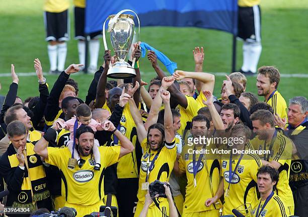 Captain Frankie Hejduk and his Columbus Crew teammates hold up the Philip F. Anschutz Trophy in celebration after defeating the New York Red Bulls...