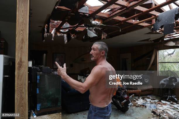 Aaron Tobias who said he lost everything stands in what is left of his home after Hurricane Harvey blew in and destroyed most of the house on August...