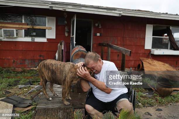 Steve Culver cries with his dog Otis as he talks about what he said was the, "most terrifying event in his life," when Hurricane Harvey blew in and...