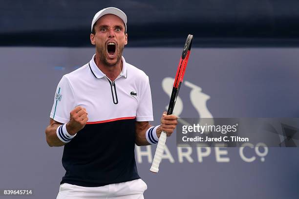 Roberto Bautista Agut of Spain reacts as he defeats Damir Dzumhur of Bosnia and Herzegovina after match point during the men's singles championship...