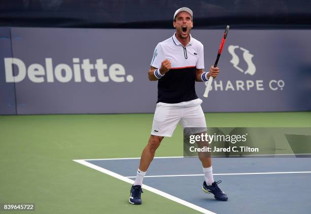 Roberto Bautista Agut of Spain reacts as he defeats Damir Dzumhur of Bosnia and Herzegovina after match point during the men's singles championship...