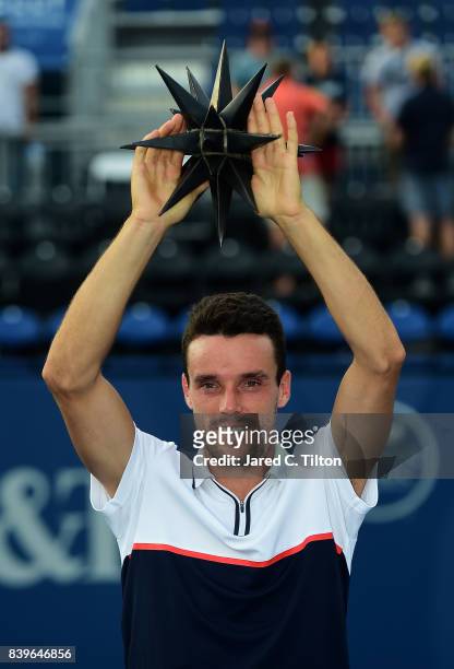 Roberto Bautista Agut of Spain poses with the trophy after defeating Damir Dzumhur of Bosnia and Herzegovina in the men's singles championship final...