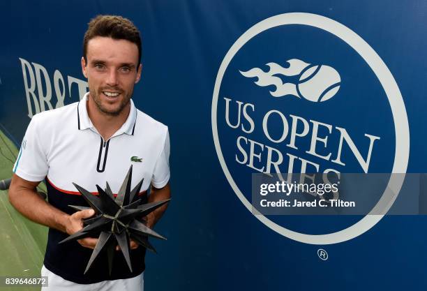 Roberto Bautista Agut of Spain poses with the trophy after defeating Damir Dzumhur of Bosnia and Herzegovina in the men's singles championship final...