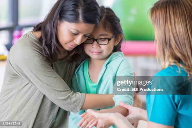 mom comforts injured child - philippine childrens medical center stock pictures, royalty-free photos & images