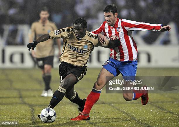 Marseille's Taye Taiwo vies with Atletico Madrid's Giourkas Seitaridis during the Champions League football match Marseille vs Atletico Madrid, on...