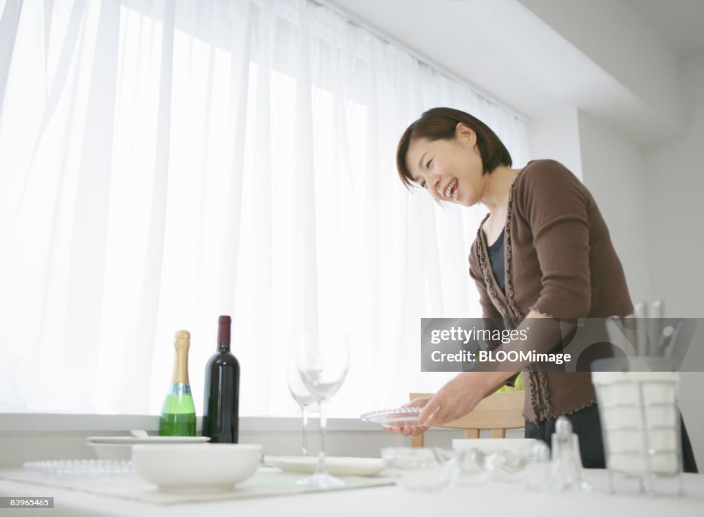 Mature woman setting the table