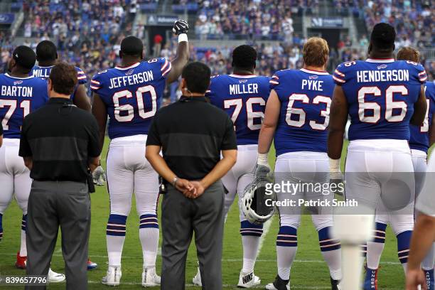 Offensive tackle Cameron Jefferson of the Buffalo Bills raises his arm and makes a fist during the national anthem before playing against the...