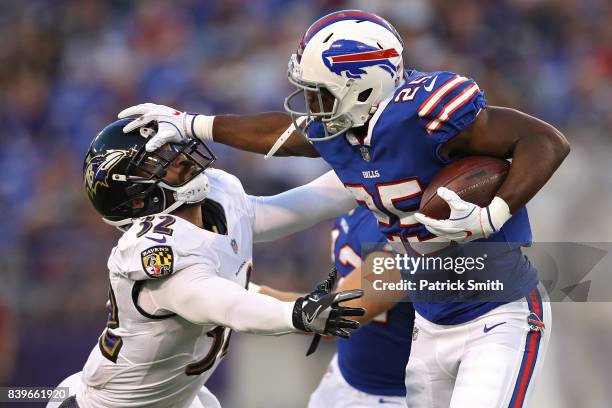 Running back LeSean McCoy of the Buffalo Bills stiff arms strong safety Eric Weddle of the Baltimore Ravens in the first half during a preseason game...