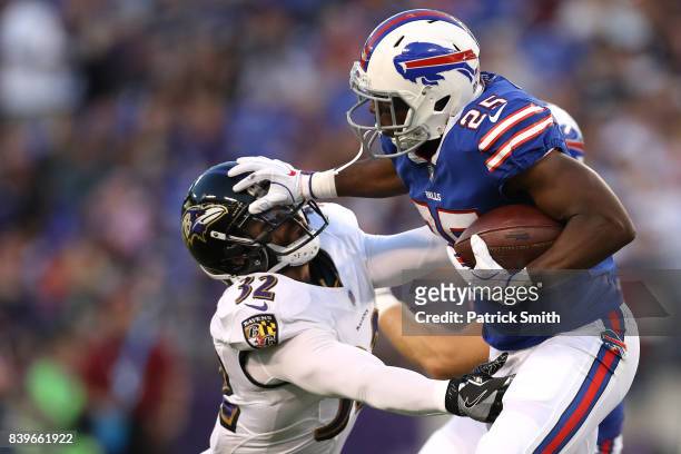 Running back LeSean McCoy of the Buffalo Bills stiff arms strong safety Eric Weddle of the Baltimore Ravens in the first half during a preseason game...