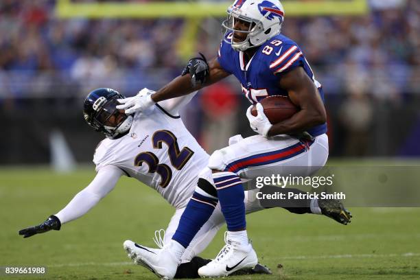 Running back LeSean McCoy of the Buffalo Bills stiff arms strong safety Eric Weddle of the Baltimore Ravens in the first half during a preseason game...