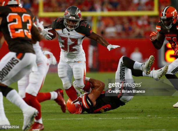 Running back Jacquizz Rodgers of the Tampa Bay Buccaneers is stopped by outside linebacker Joe Schobert of the Cleveland Browns during the first...