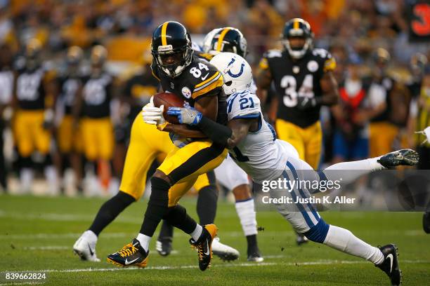 Antonio Brown of the Pittsburgh Steelers is tackled by Vontae Davis of the Indianapolis Colts during a preseason game on August 26, 2017 at Heinz...