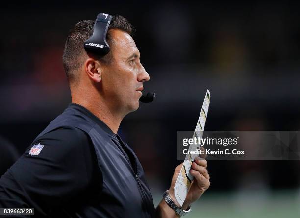 Offensive coordinator Steve Sarkisian of the Atlanta Falcons calls plays from the sidelines during the game against the Arizona Cardinals at...