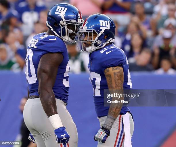 Jason Pierre-Paul and Darian Thompson of the New York Giants celebrate a stop in the first quarter against the New York Jets during a preseason game...