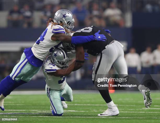 Jaylon Smith of the Dallas Cowboys and Byron Jones of the Dallas Cowboys combine to stop Jared Cook of the Oakland Raiders in the second quarter of a...