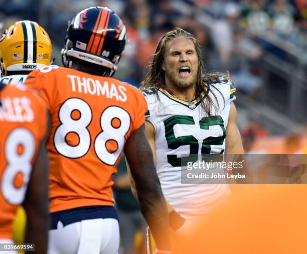 Denver Broncos wide receiver Demaryius Thomas and Green Bay Packers outside linebacker Clay Matthews chat during a timeout in the first quarter on...