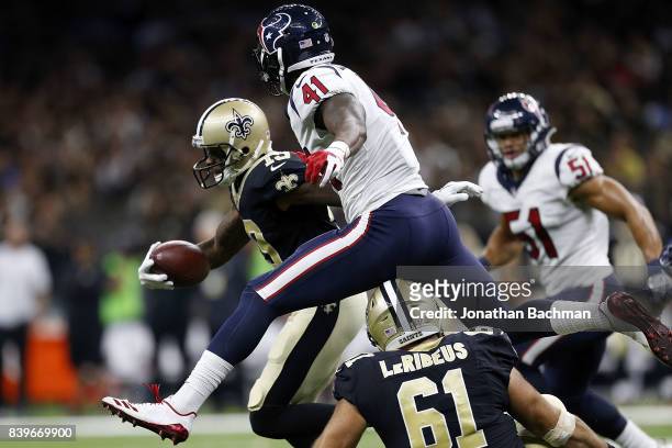 Zach Cunningham of the Houston Texans leaps over Josh LeRibeus of the New Orleans Saints in an attempt to tackle Ted Ginn during the first half of a...
