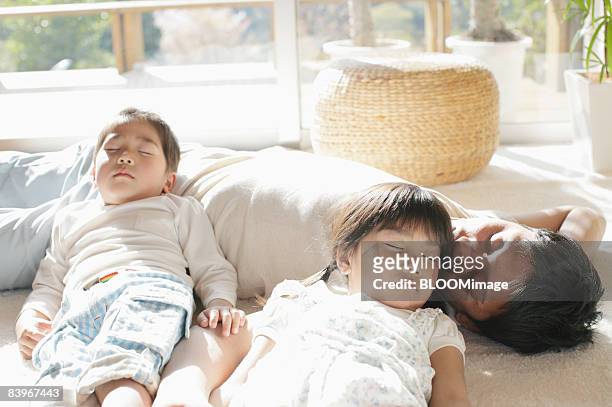 father and children taking a nap - lying on back photos stock pictures, royalty-free photos & images