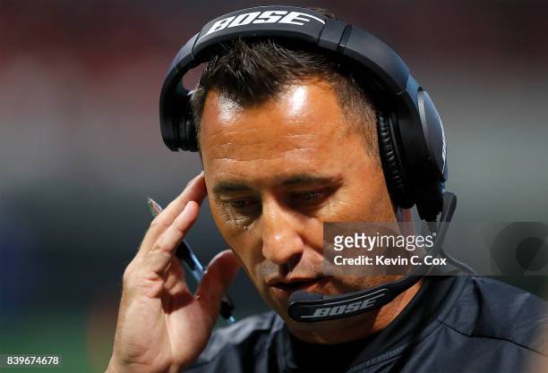 Offensive coordinator Steve Sarkisian of the Atlanta Falcons calls plays from the sidelines during the game against the Arizona Cardinals at...