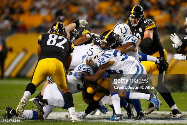 Terrell Watson of the Pittsburgh Steelers rushes against T.J. Green of the Indianapolis Colts during a preseason game on August 26, 2017 at Heinz...