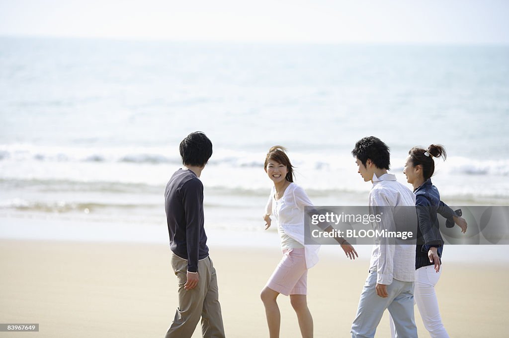 Men and women walking in beach