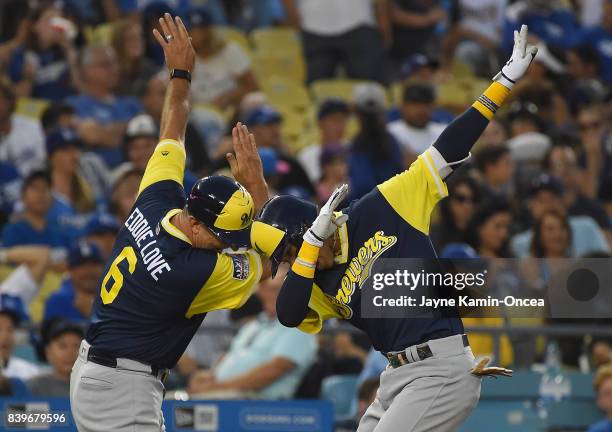 Orlando Arcia of the Milwaukee Brewers celebrates a two run home run with third base coach Ed Sedar of the Milwaukee Brewers in the fifth inning of...