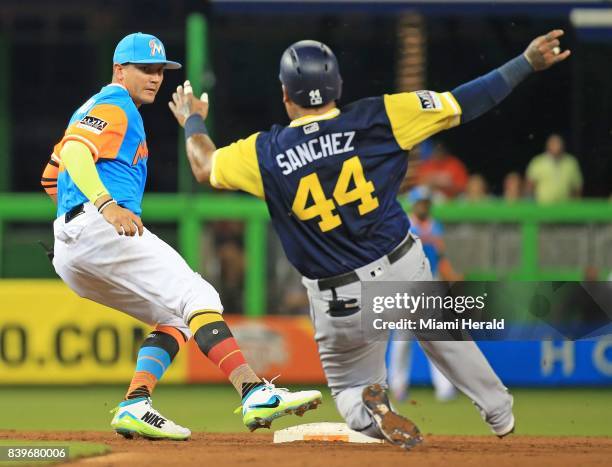 Miami Marlins shortstop Miguel Rojas beats the San Diego Padres' Hector Sanchez to the bag for a second-inning out at Marlins Park in Miami on...