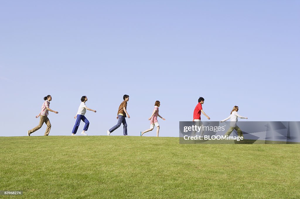 Walk In A Line Men And Women Walking In Line On Hill High-Res Stock Photo - Getty Images