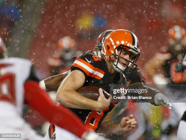 Quarterback Kevin Hogan of the Cleveland Browns is tackled on the run by linebacker Cameron Lynch of the Tampa Bay Buccaneers during the fourth...